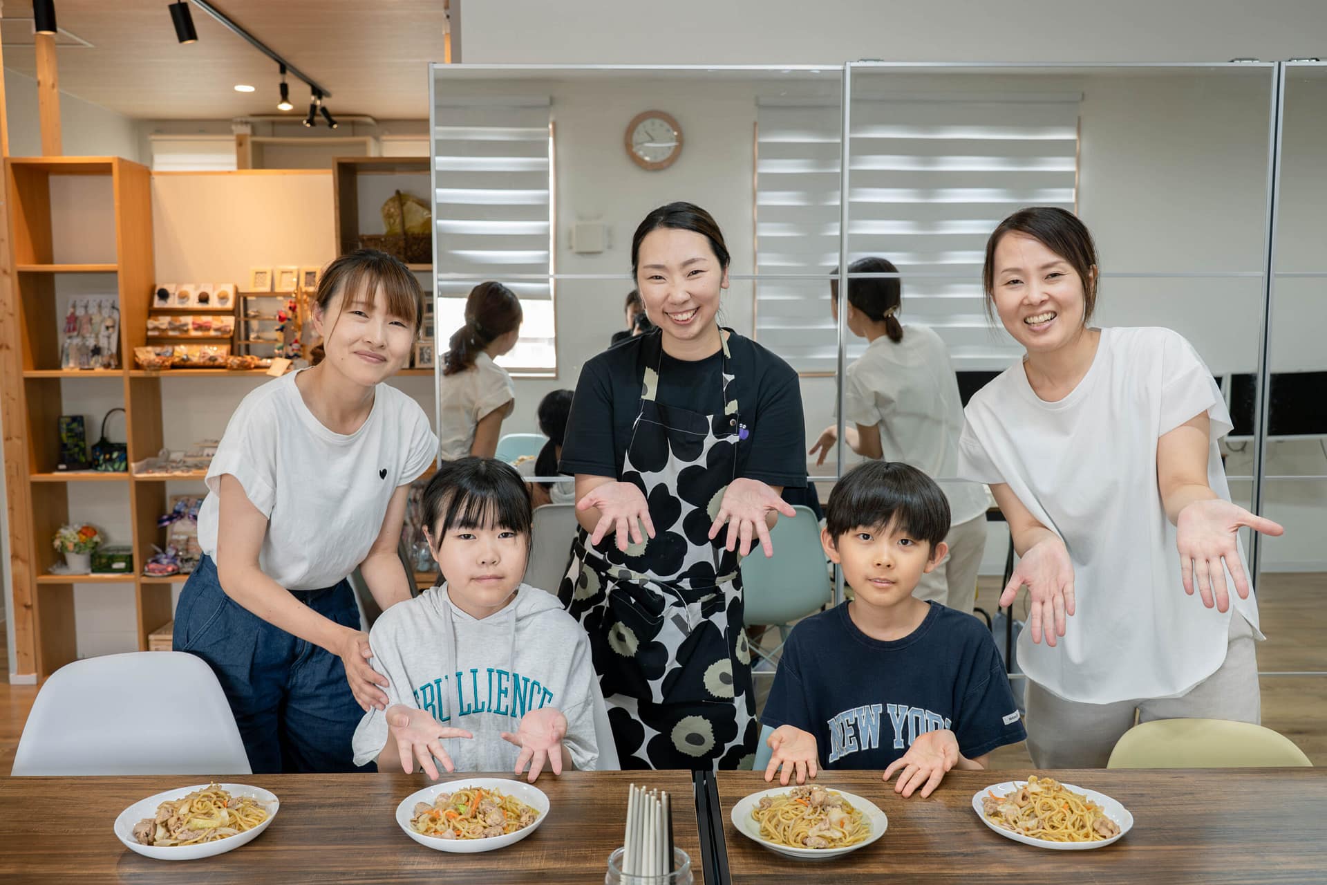 大人と子どもが料理の並んだ机を囲んでいる